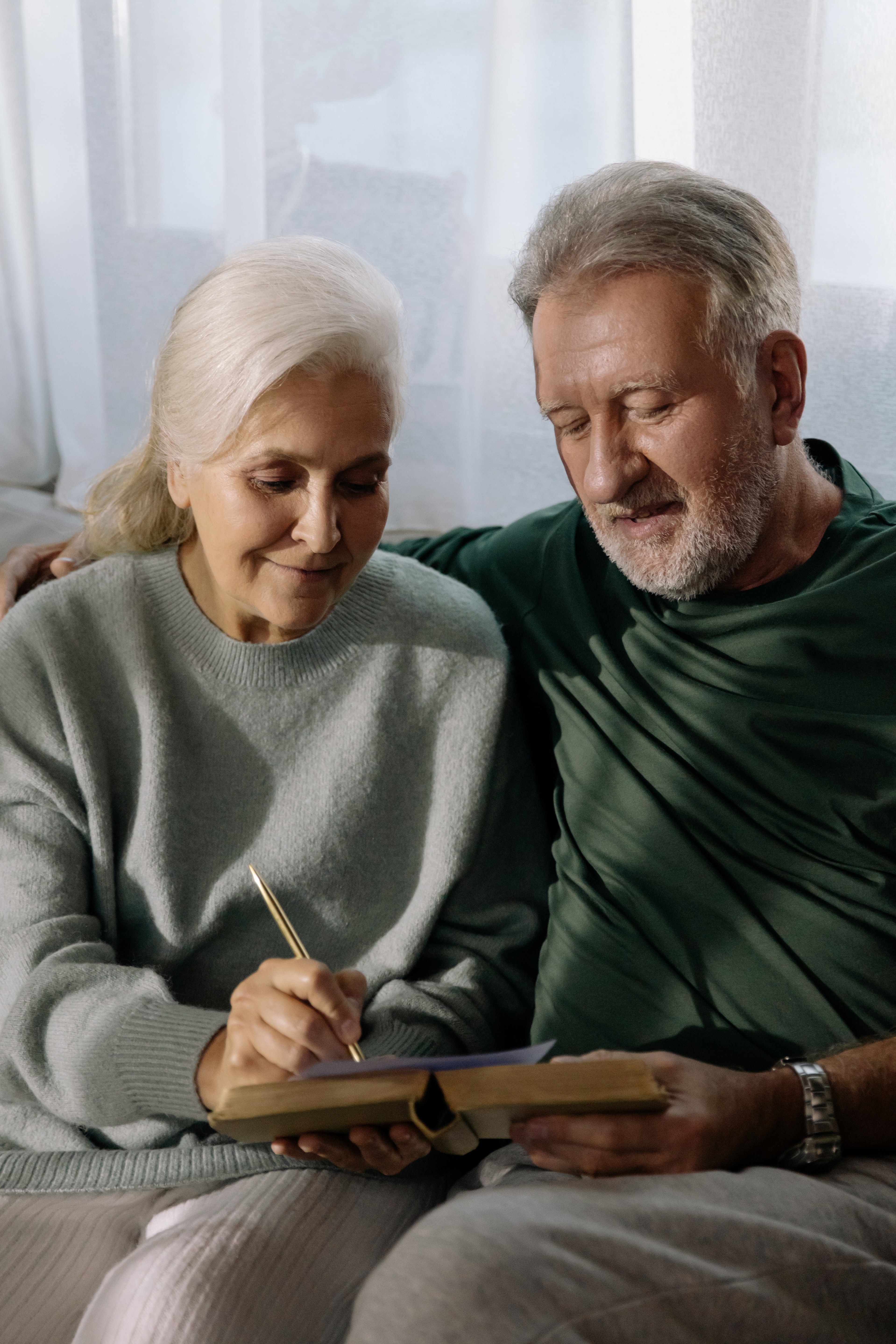 senior couple reading and making notes